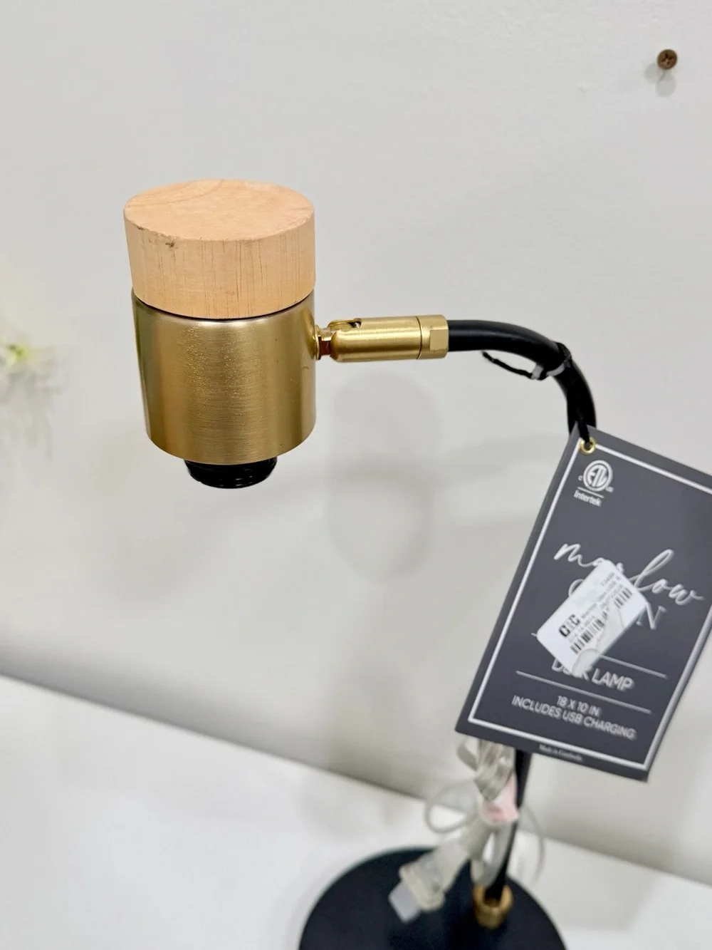 black and brass desk lamp with a small wooden accent piece on the socket